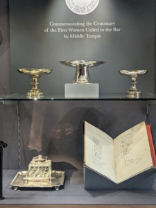 display cabinets showing silver cups commemorating first women called to the bar